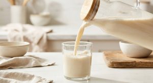 Pouring smooth creamy plant-based oat milk stabilized with gellan gum, no separation.